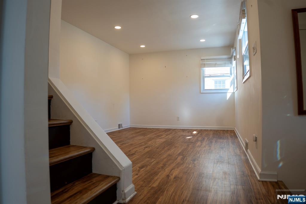 58 Elm Street Dumont, NJ 07628 - Photo 8 of 28 a view of an empty room with wooden floor and a window