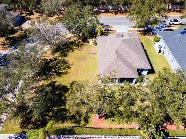 a aerial view of a house with a yard and lake view