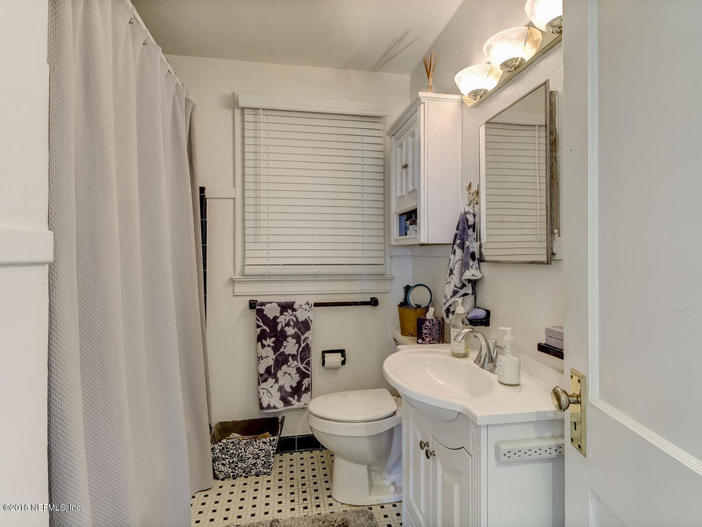 4603 Birkenhead Road Jacksonville, FL 32210 - Photo 26 of 43 a bathroom with a sink a toilet and shower curtain