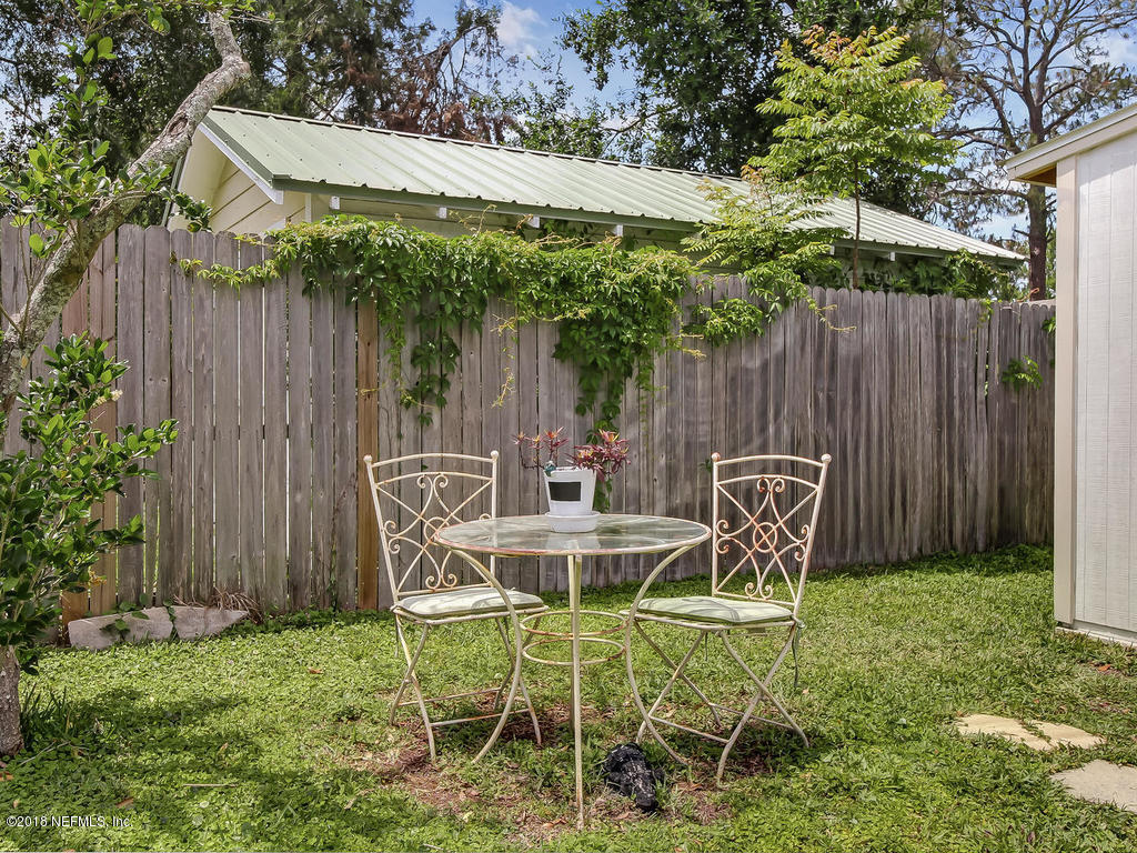 4603 Birkenhead Road Jacksonville, FL 32210 - Photo 39 of 43 a view of backyard with table and chairs and wooden fence