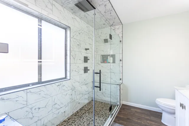 a bathroom with a shower and toilet