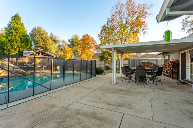 a view of a patio with table and chairs and potted plants