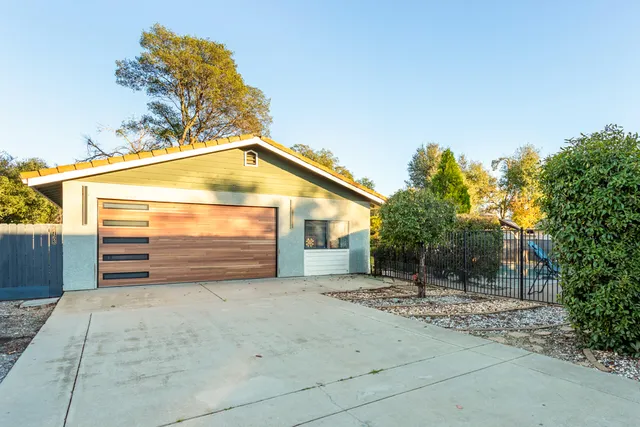 a view of a house with a yard and garage