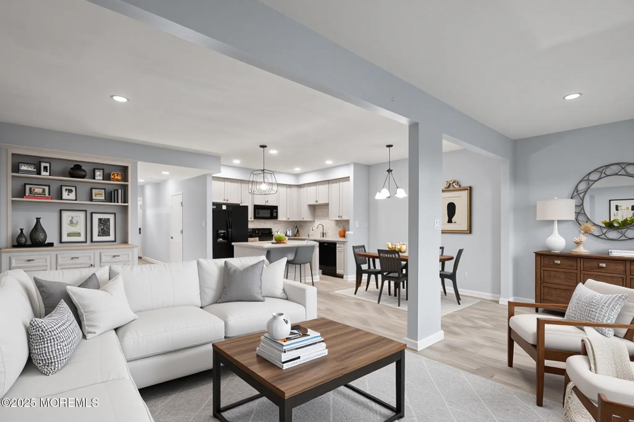 a living room with furniture kitchen view and a table