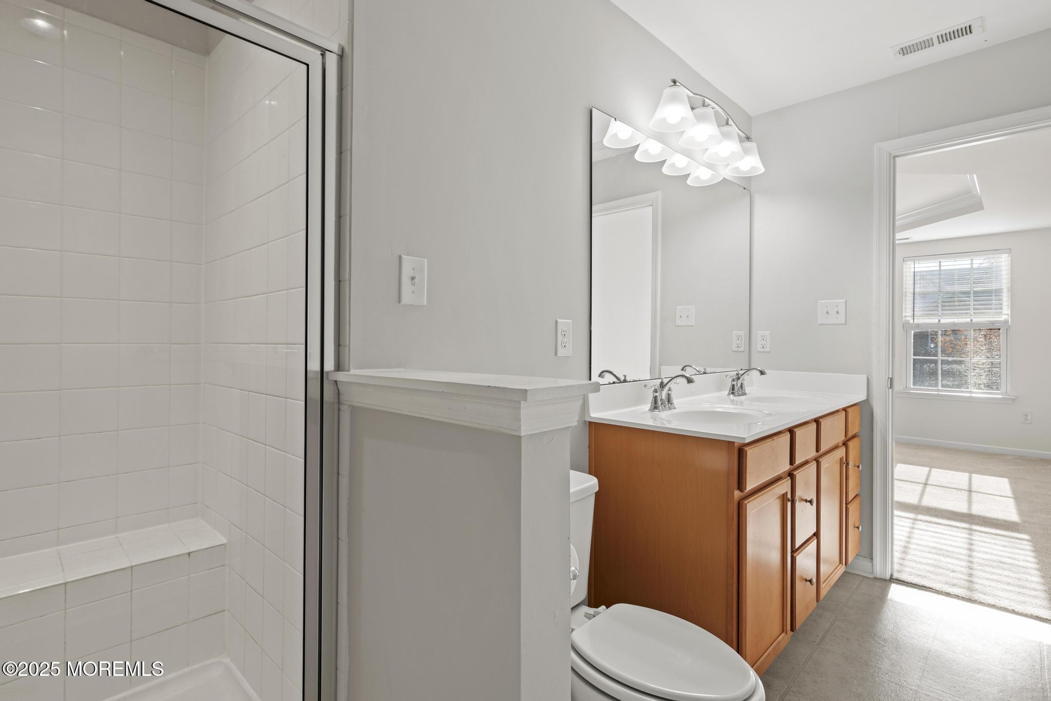 125 Sundance Drive Hamilton, NJ 08619 - Photo 17 of 31 a bathroom with a sink a toilet and shower