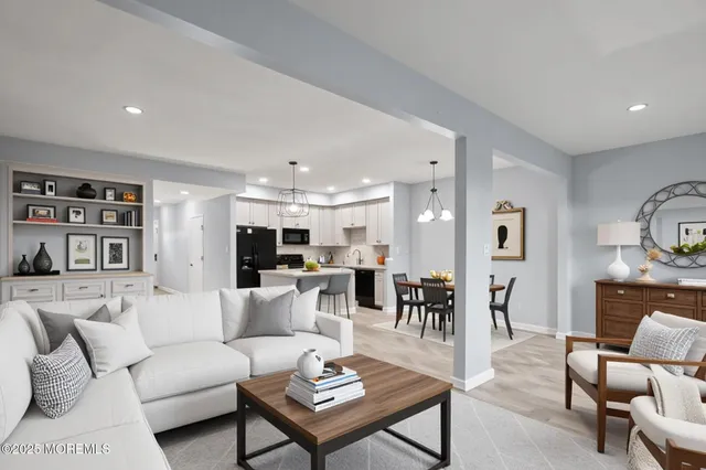 a living room with furniture kitchen view and a table