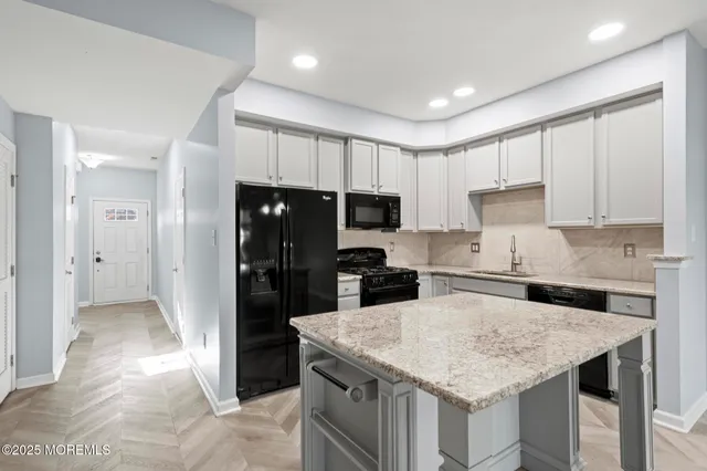 a view of kitchen with refrigerator sink and microwave