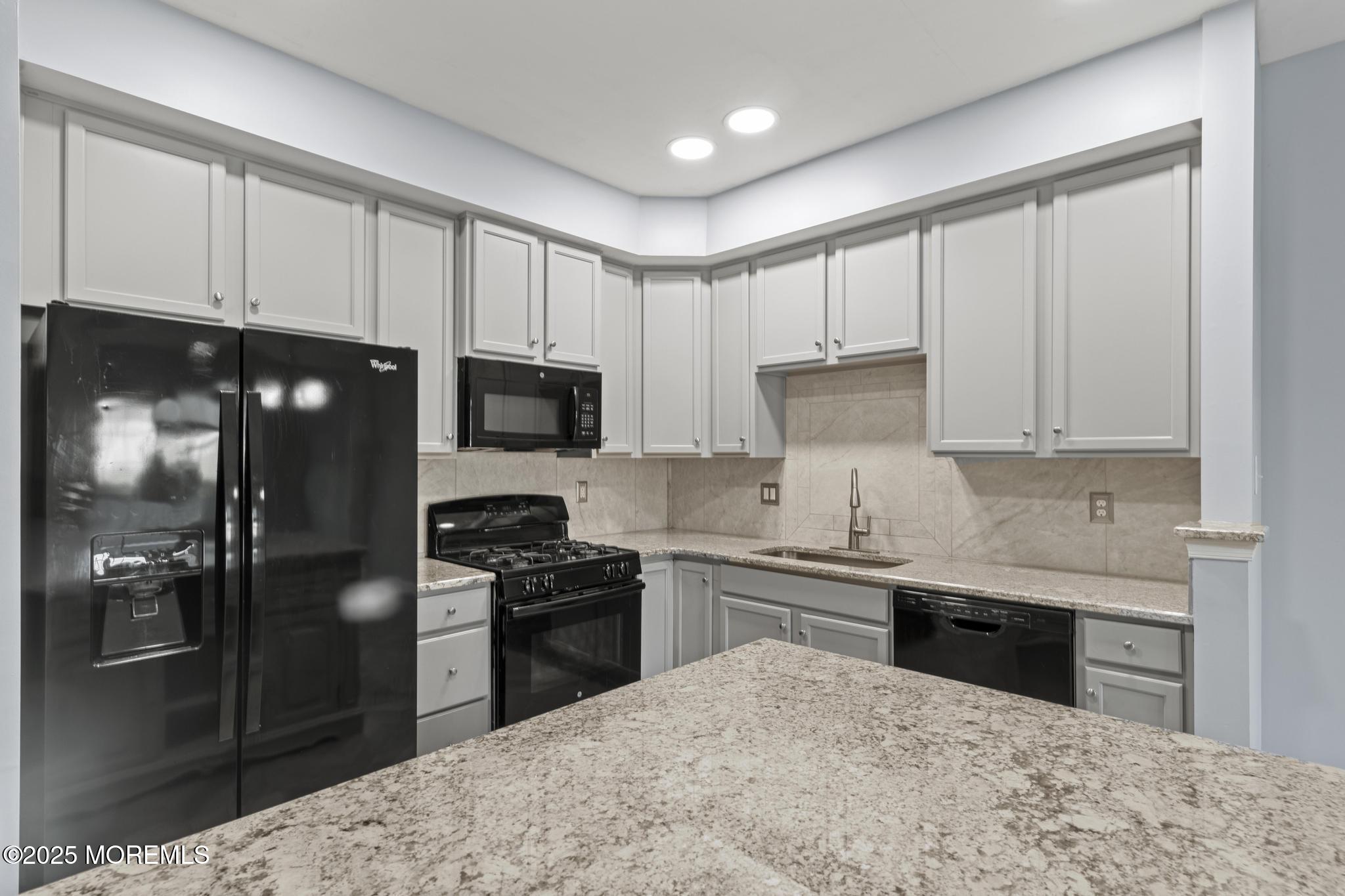 125 Sundance Drive Hamilton, NJ 08619 - Photo 7 of 31 a kitchen with stainless steel appliances kitchen island granite countertop a refrigerator stove and sink