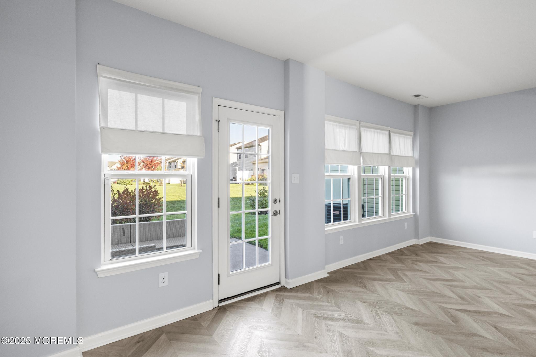 125 Sundance Drive Hamilton, NJ 08619 - Photo 9 of 31 an empty room with wooden floor and windows