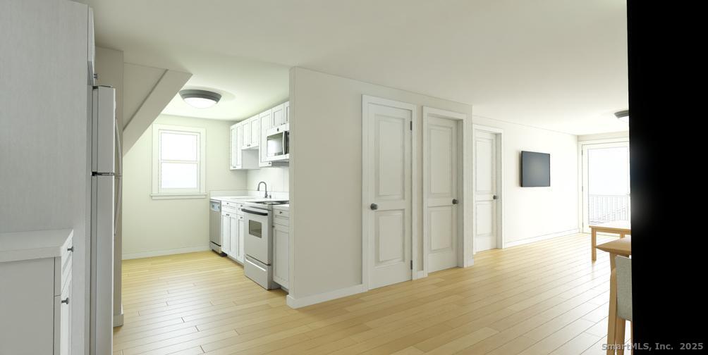 16 Hillside Street West Haven, CT 06516 - Photo 2 of 3 a view of a kitchen with a sink and a refrigerator