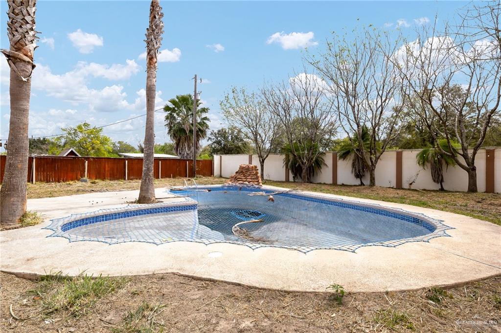 1315 Ruger Street Donna, TX 78537 - Photo 15 of 17 The property features an outdoor pool with blue tiling, surrounded by a concrete patio