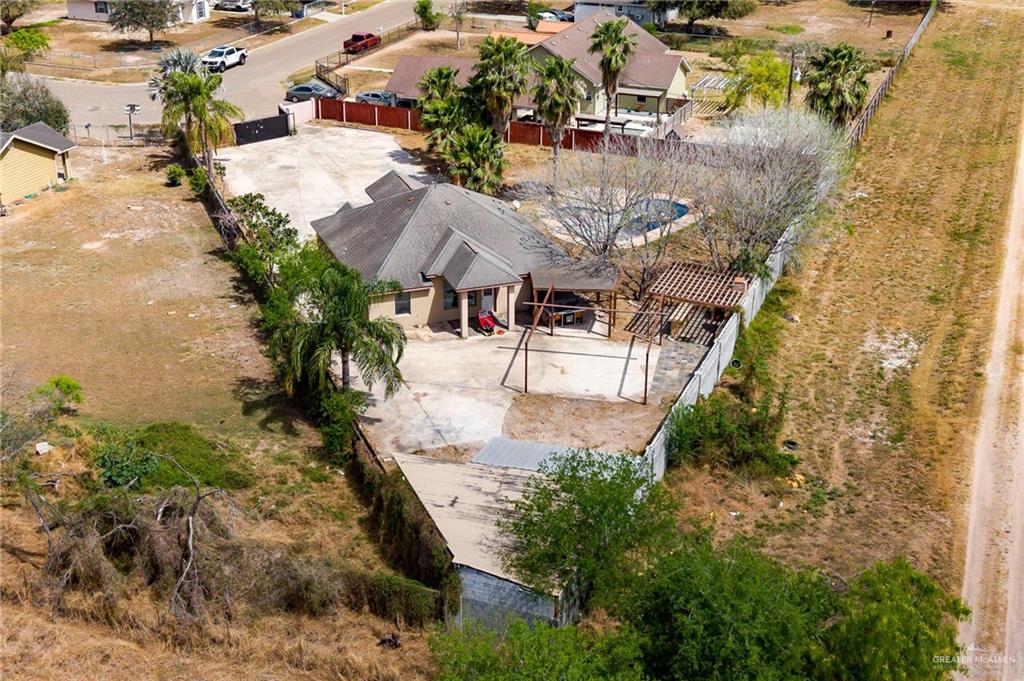 1315 Ruger Street Donna, TX 78537 - Photo 17 of 17 This property features a swimming pool, a covered patio area, and a large paved driveway
