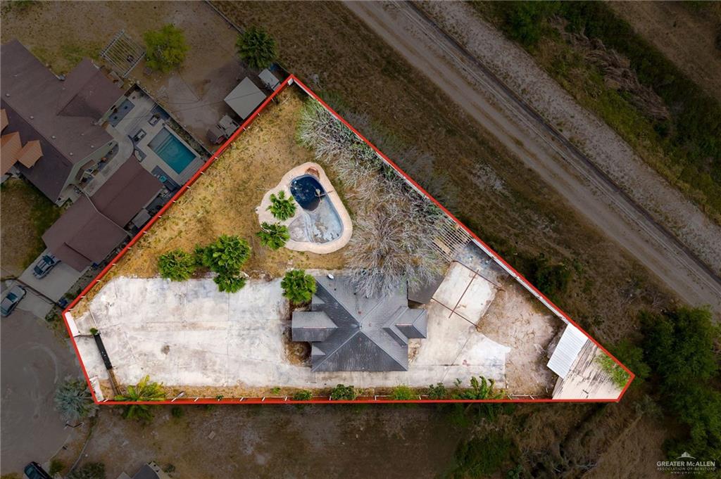 1315 Ruger Street Donna, TX 78537 - Photo 2 of 17 Aerial view highlighting the property's large lot, which includes a swimming pool, several trees, and a paved area