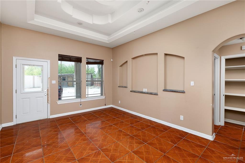 1315 Ruger Street Donna, TX 78537 - Photo 5 of 17 The property features a spacious room with patterned tile flooring and a decorative tray ceiling