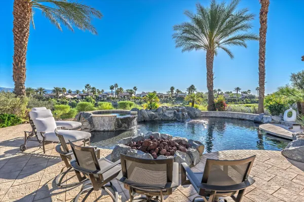 a view of a chairs and table in patio with a lake view