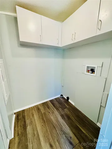 a view of kitchen with white cabinets
