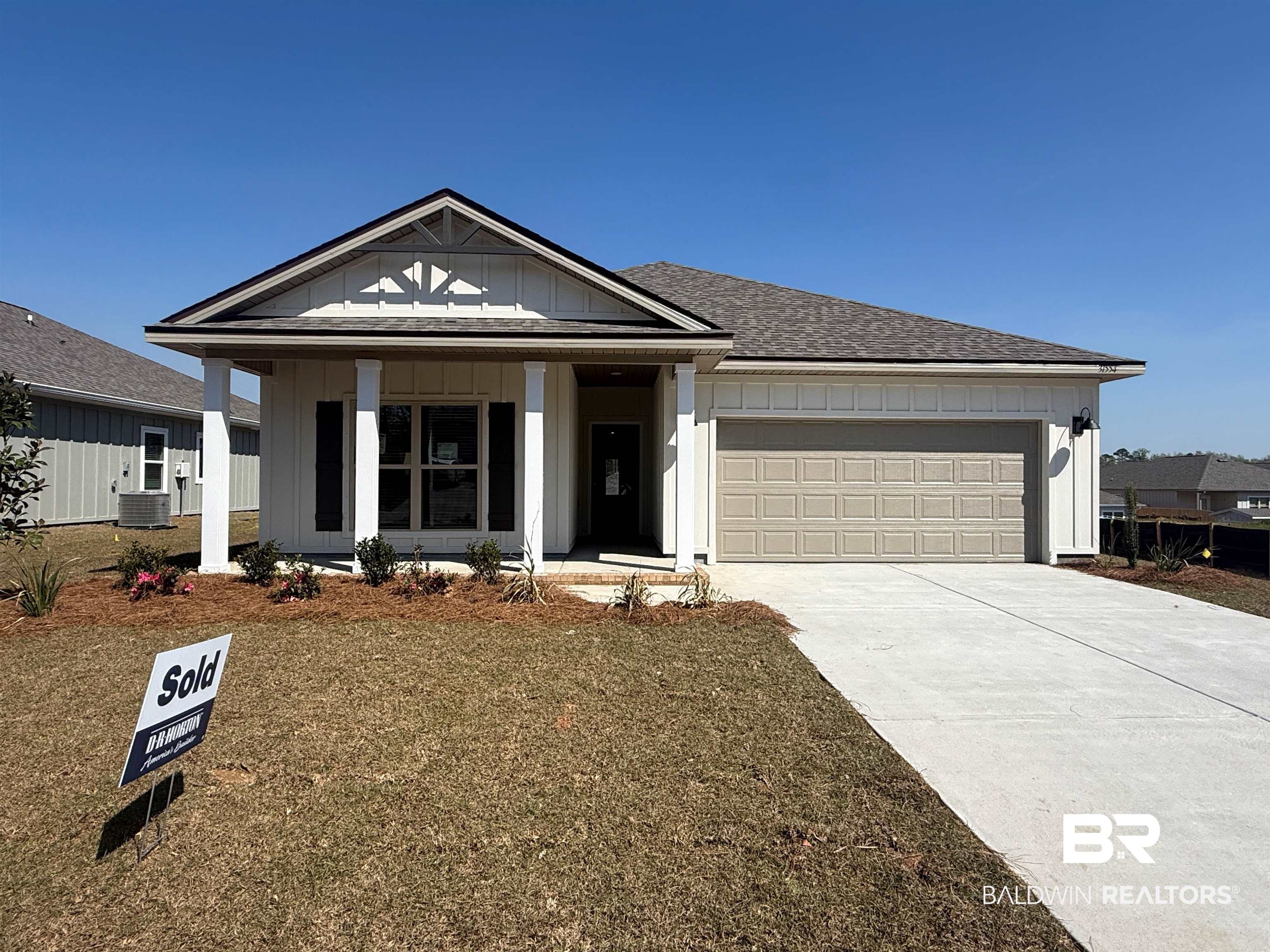 31554 Lyon Road Daphne, AL 36527 - Photo 1 of 48 View of front of home featuring board and batten siding, a porch, driveway, and a garage