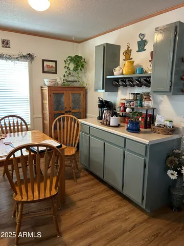 a kitchen with stainless steel appliances a dining table and chairs