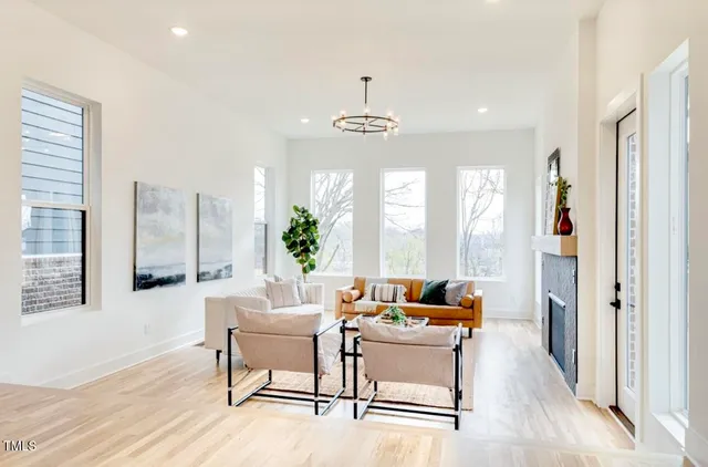 a dining room with furniture a chandelier and wooden floor