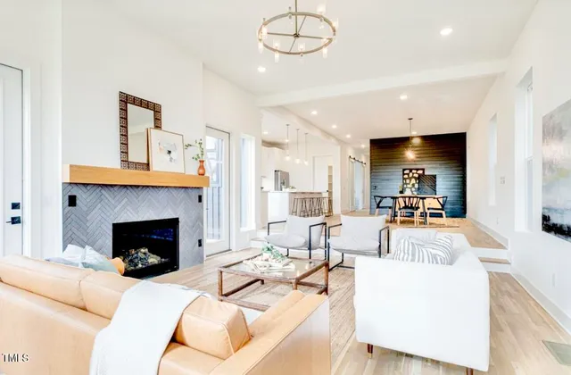 a living room with furniture fireplace and a large mirror