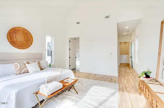 a bedroom with a bed and flowerpot