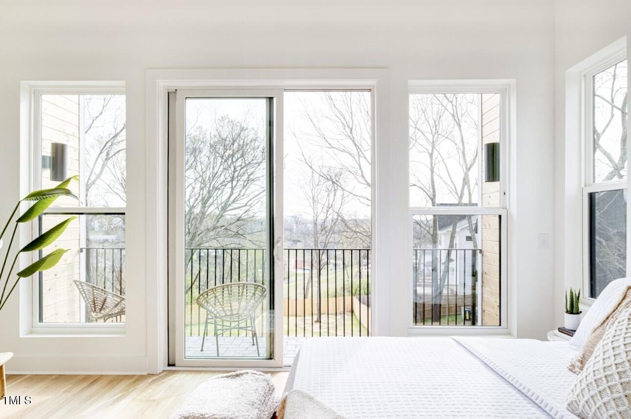 322 South Dixon Avenue, Unit R Cary, NC 27511 - Photo 25 of 37 a bedroom with a bed and wooden floor