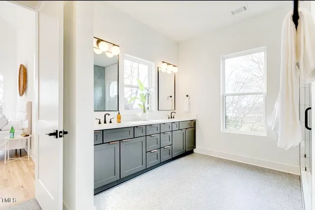 a bathroom with 2 sink tub shower and a mirror