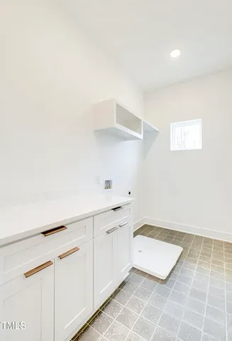 a room with a white cabinets and a rug