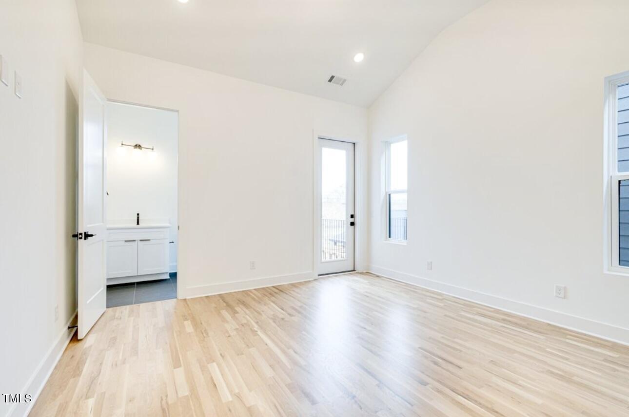 322 South Dixon Avenue, Unit R Cary, NC 27511 - Photo 31 of 37 an empty room with wooden floor and windows