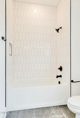a bathroom with a bathtub and shower