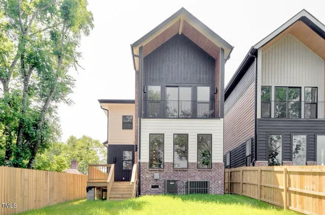 a view of a house with swimming pool and a yard
