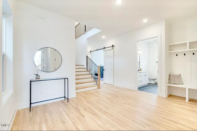 a view of a room with wooden floor and a bathroom