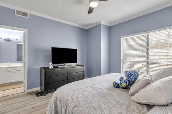 a bedroom with a bed and a flat screen tv