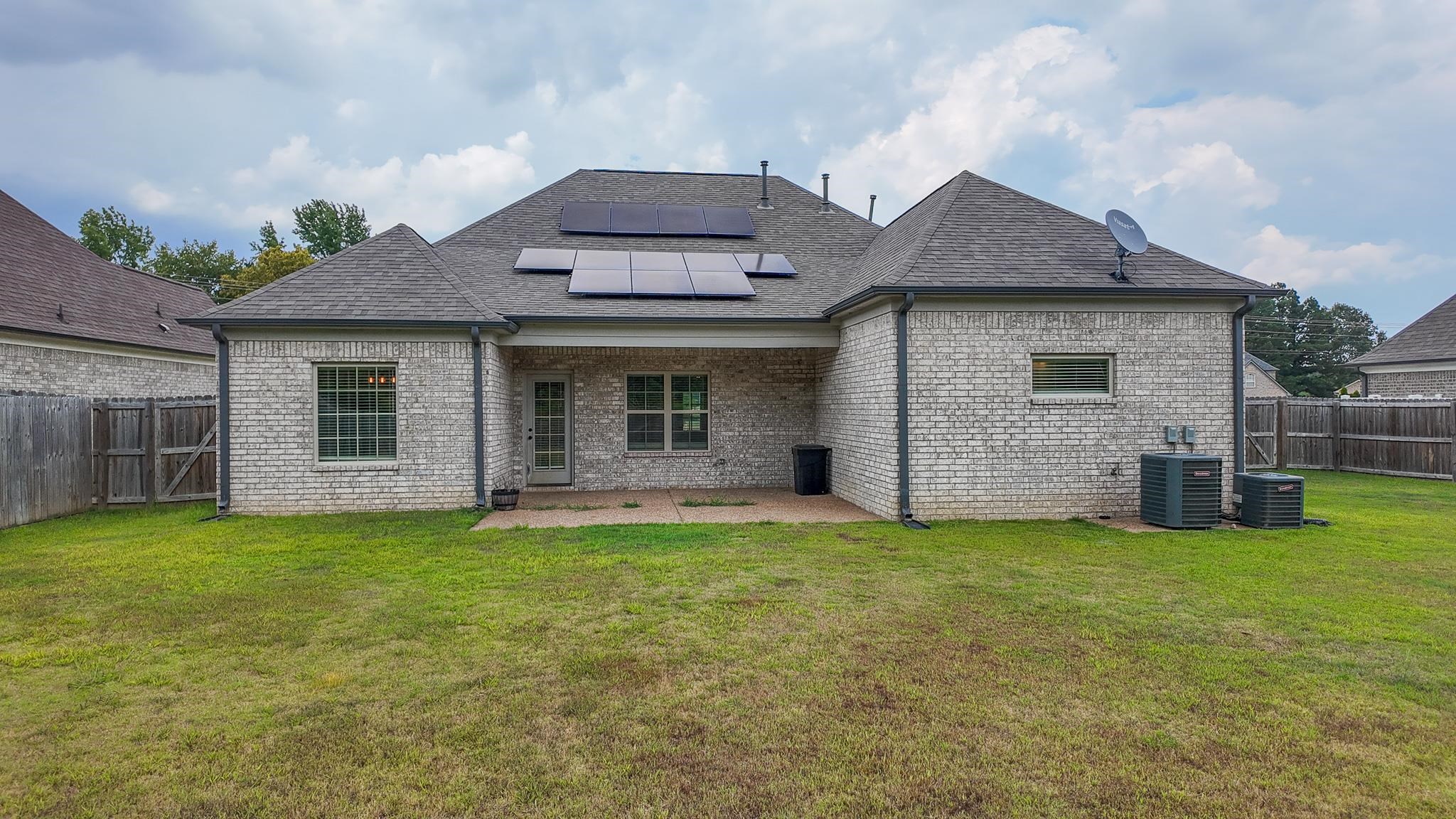 5217 Nail Road Olive Branch, MS 38654 - Photo 27 of 35 Back of property featuring a fenced backyard, solar panels, brick siding, and a patio