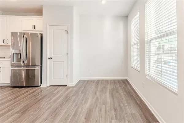 a view of kitchen with wooden floor electronic appliances and window