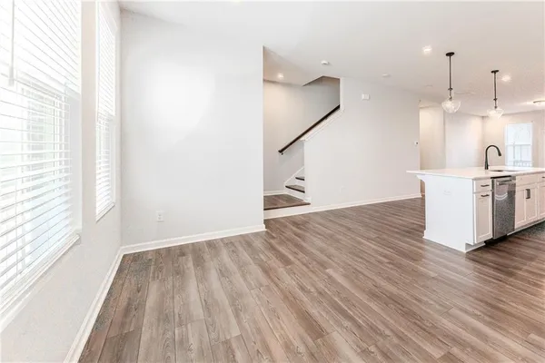 a view of a kitchen with wooden floor and electronic appliances