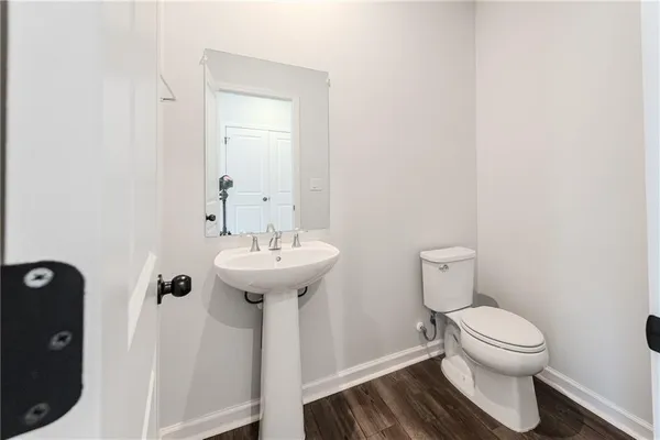 a bathroom with a sink toilet and a mirror