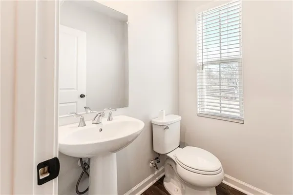 a white toilet sitting next to a bathroom sink