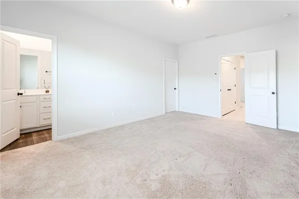 a bathroom with a shower sink vanity mirror and toilet