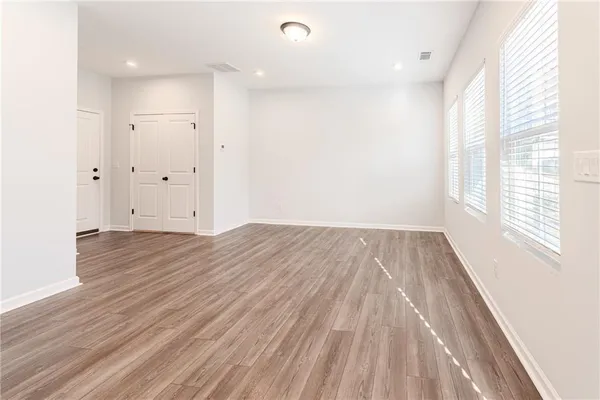 a view of a room with wooden floor and window