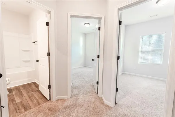 wooden floor with a bathroom and a sink