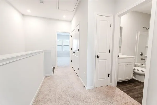a kitchen with stainless steel appliances kitchen island granite countertop a table chairs and a refrigerator