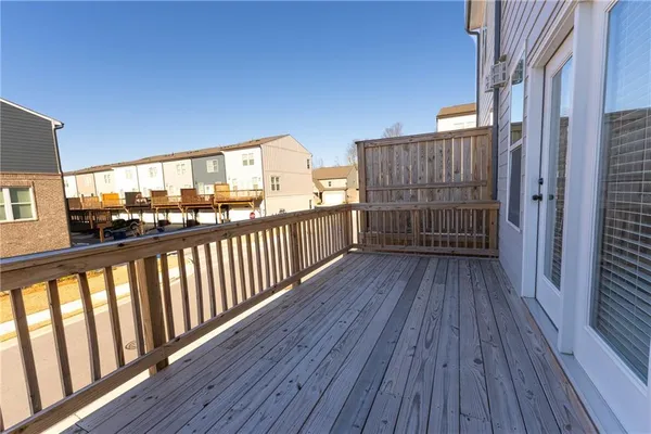 a view of a house with a wooden deck