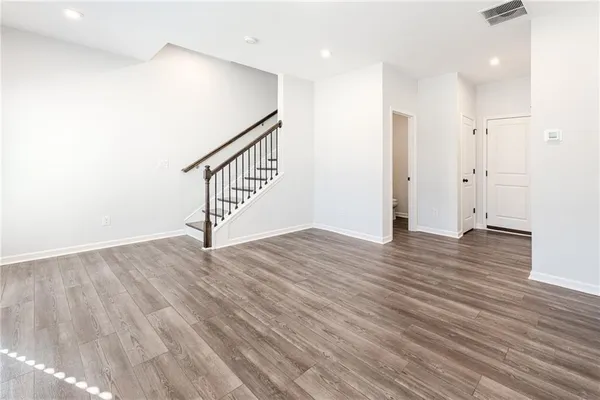 a view of a hallway with wooden floor
