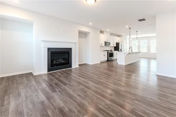 a view of a kitchen with a sink and a fireplace