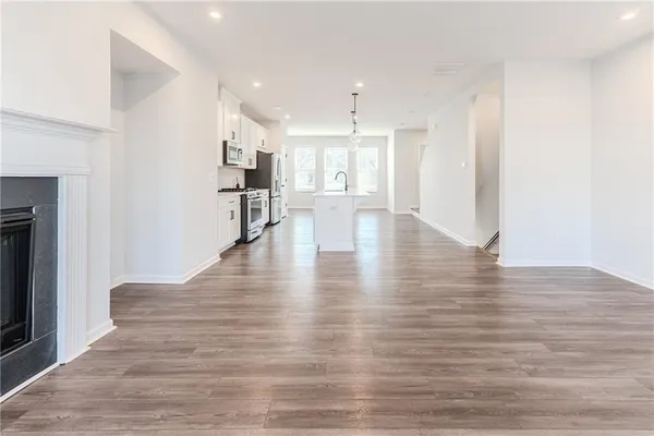 a view of kitchen and hall with wooden floor
