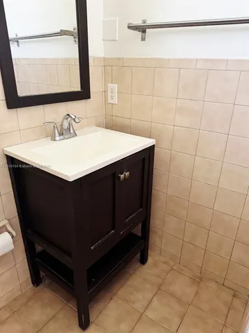 a bathroom with a sink vanity and a mirror