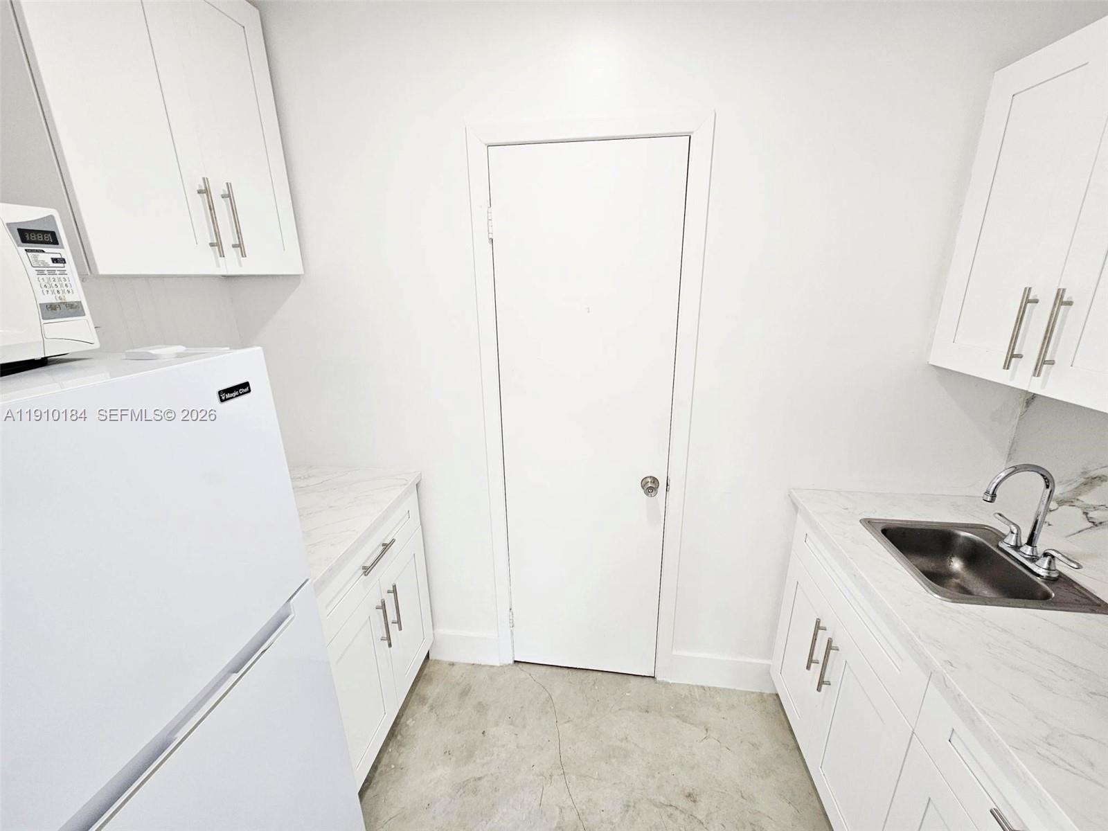 9301 Southwest 37th Street, Unit 4 Miami, FL 33165 - Photo 6 of 10 a view of a kitchen with sink and washing machine