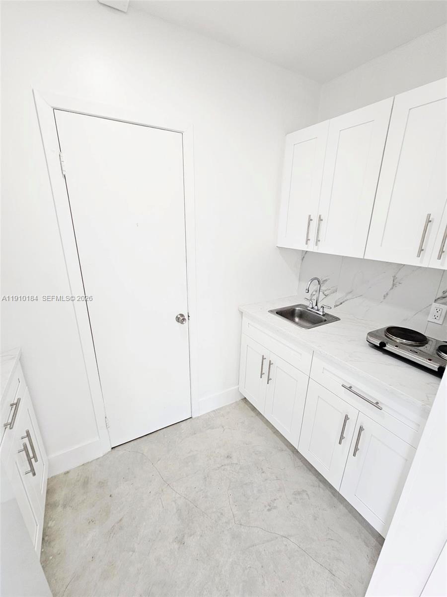 9301 Southwest 37th Street, Unit 4 Miami, FL 33165 - Photo 8 of 10 a utility room with cabinets washer and dryer