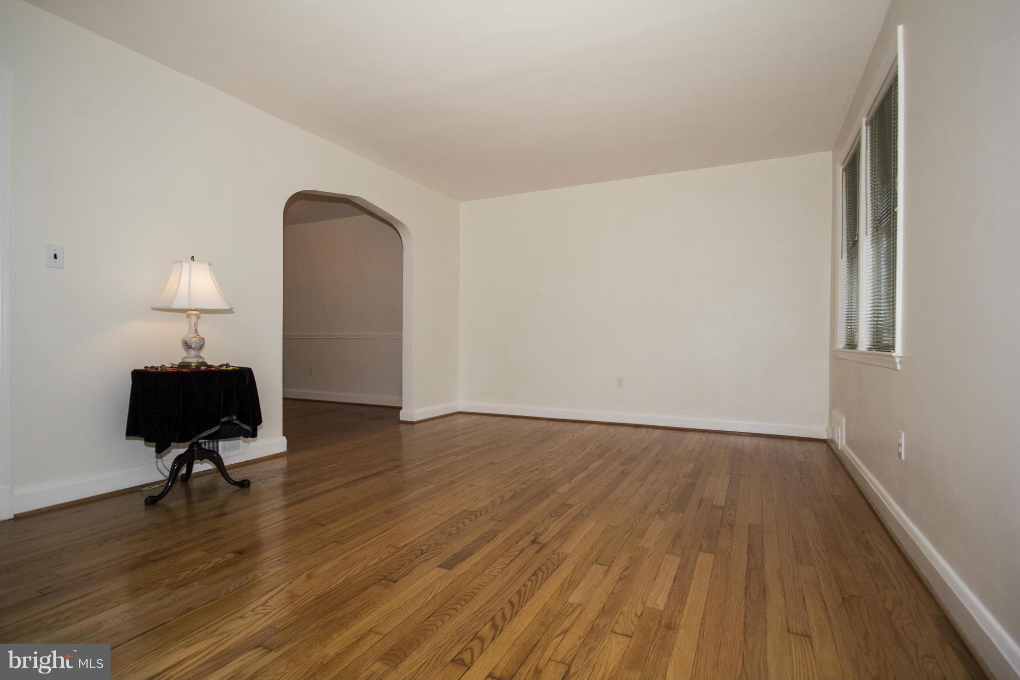 5626 Sagra Road Baltimore, MD 21239 - Photo 2 of 27 a view of room with wooden floor lounge chair and windows